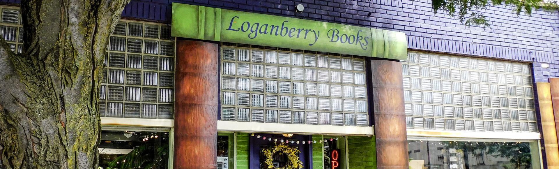 Purple building with green sign reading "Loganberry Books"