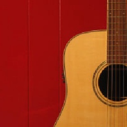 an acoustic guitar against a red background